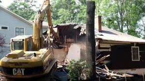 A Decatur home being demolished in 2012. The house, which had been bought by a developer, had closets full of clothes and a full attic of belongings from the family that last lived there. Photo by the author.
