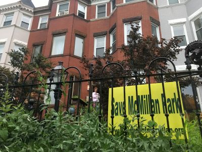 The Save McMillan party was held inside a historic Bloomingdale rowhouse. It is one of many in the neighborhood with the distinctive yellow signs produced by the preservation advocates. Photo credit: David Rotenstein.