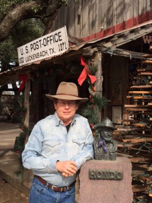 At the historic Luckenbach, Texas store and dance hall with bust of Texas legend Honda Crouch. Photo credit: Patrick Cox.