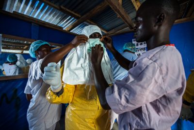 Felicia, a 29-year-old Liberian nurse, prepares to go inside the Ebola patient ward to draw blood from confirmed patients in Bong County, Liberia on October 9, 2014. Photograph by Morgana Wingard, courtesy USAID