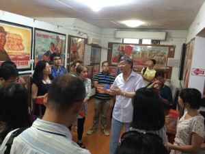 Seminar participants receiving an introduction to the Shanghai Propaganda Poster Art Centre from museum director Yang Pei Ming.  Photo credit: Richard Anderson 