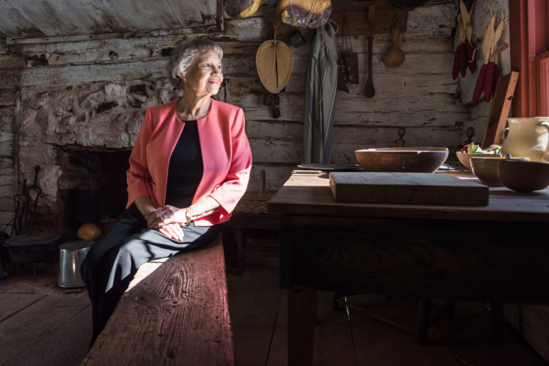 Rebecca Gilmore Coleman, a member of the James Madison's Montpelier Descendant Community, sitting inside her ancestors' restored farm home, which is now on Montpelier property (Photo by Eduardo Montes Bradley, Courtesy of the Montpelier Foundation)