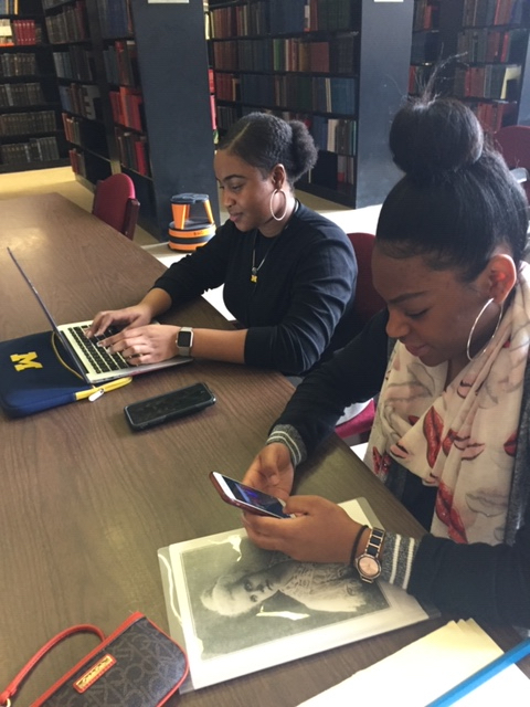 Students conducting research and taking digital photos, with Professor Tiya Miles, at the Detroit Public Library. Used by permission of Cynthia Long, Detroit Study Club Member.