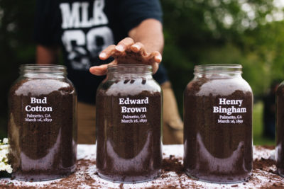 This image depicts three jars of soil from the sites where Bud Cotton, Edward Brown, and Henry Bingham were lynched in 1899.