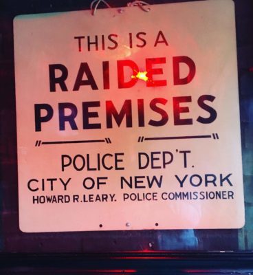 A historic notice posted inside the Stonewall Inn reading, "This is a raided premises" and signed by the New York police commissioner in 1969.