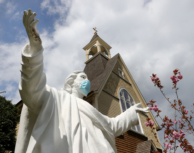 A statue of Jesus Christ outside of<a href=”https://pandemicreligion.org/s/contributions/item/37”>Our Lady Star of the Sea Church</a> in Atlantic City, New Jersey wearing a protective face mask.
