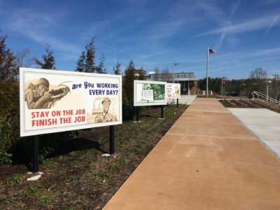 The outside entrance to the K-25 History Center with historic billboards lining the sidewalk