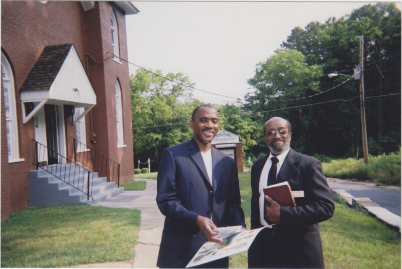 Doyal Hill, Acworth's first Black elected official (right), and Pastor Frank Johnson, Jr. in front of Zion Hill Missionary Baptist Church, Taylor Street, Acworth, Georgia, 2007. 