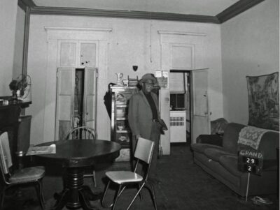 Photograph of musician Jimmy Strawn, standing in his Albany, New York apartment before demolition for the Empire State Plaza, Jan. 11, 1963