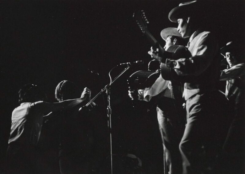 The members of Los Tigres del Norte perform in front of microphones at the 1970 Berkeley Folk Music Festival.
