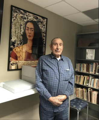 Raymond Martinez poses for a photo in the Iowa Women’s Archives reading room. 