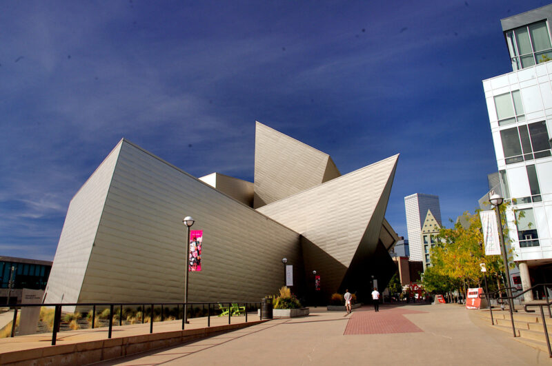 The exterior of the angular, gray metal, post-modern museum building in downtown Denver.