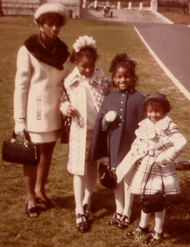 A woman and three girls dressed in their Sunday best.