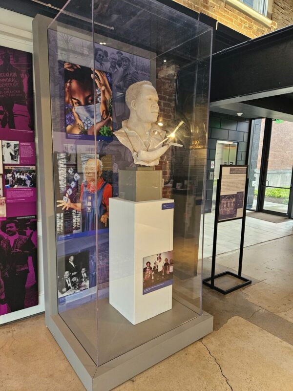 A bust of a man with four different images in the form of artwork and photos.
