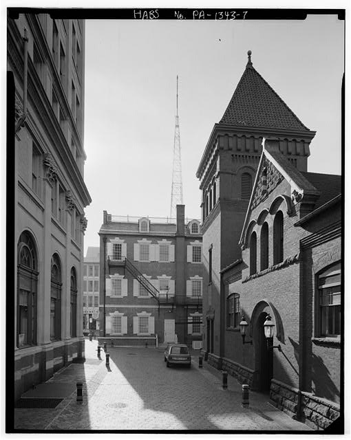 Historic photograph of Lancaster's Old City Hall, a three-story brick building with a prominent clock tower and cupola.